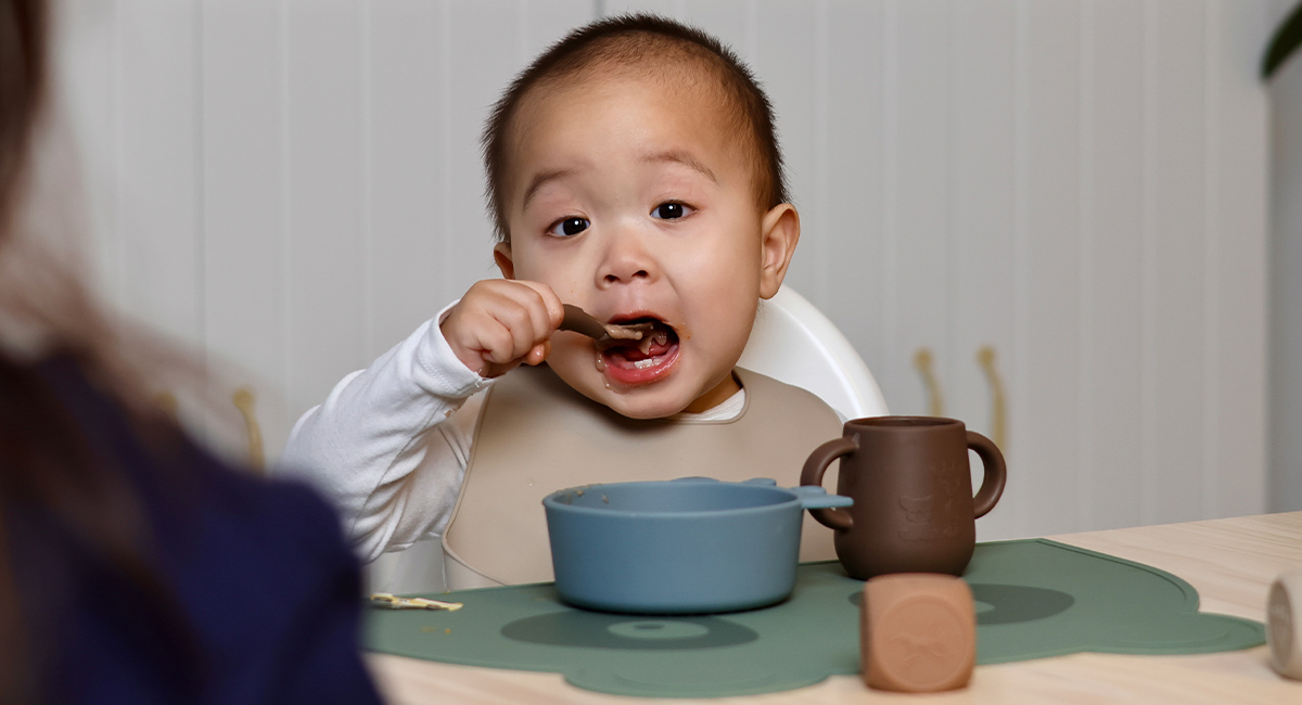 Banner baby with brown spoon