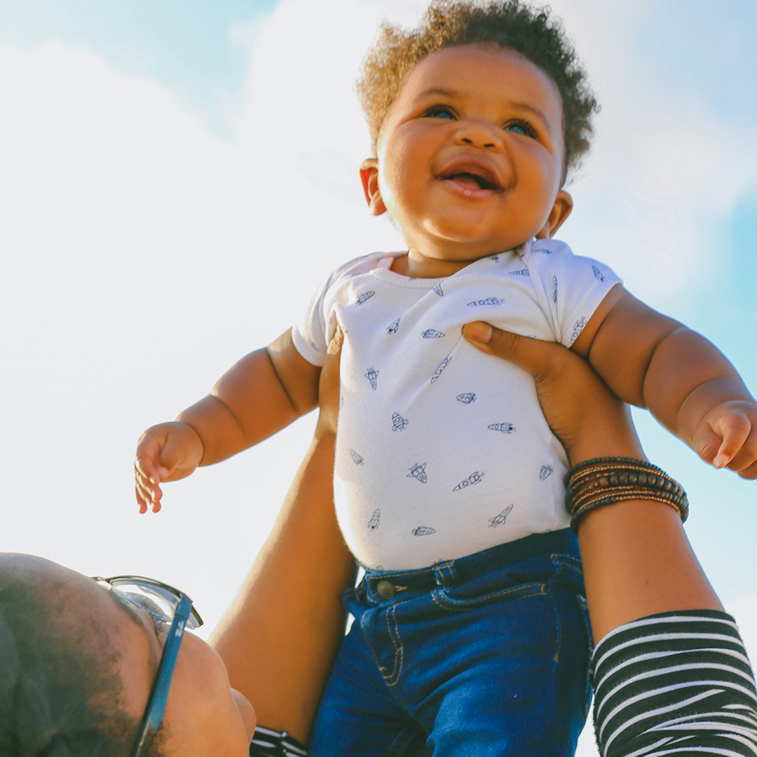 Mother lifting baby