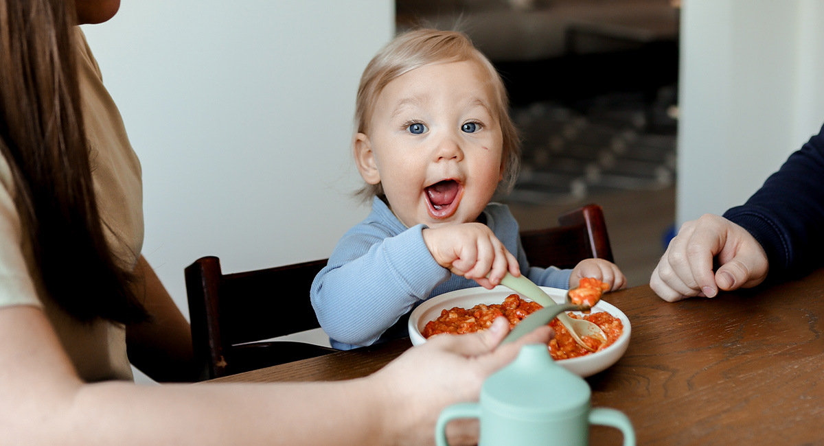 Baby eating with parents