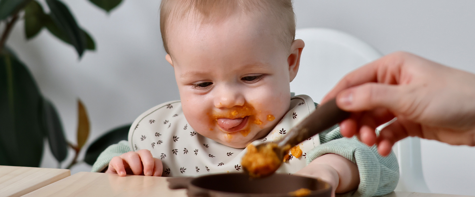 Happy baby eating Semper baby food